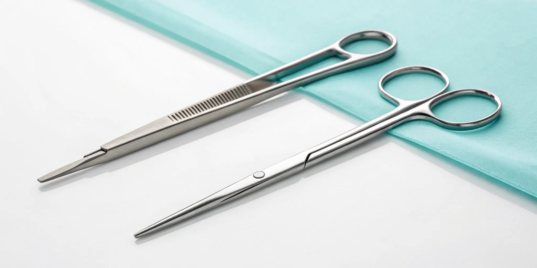 A hemostat vs a needle driver, comparing their functions for bleeding control and suturing precision.